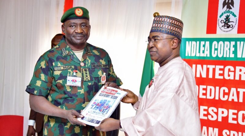 Chairman/Chief Executive Officer of the National Drug Law Enforcement Agency, NDLEA, Brig. Gen. Mohamed Buba Marwa (Retd) presenting a copy of the agency's official magazine to the Chief of Defence Staff, Gen. Christopher Musa when the latter paid him a courtesy visit at the NDLEA's national headquarters in Abuja on Monday 18th December 2023